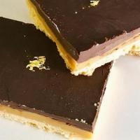 Millionaire Bars · Shortbread crust, homemade caramel and dark chocolate ganache layered and topped with edible...