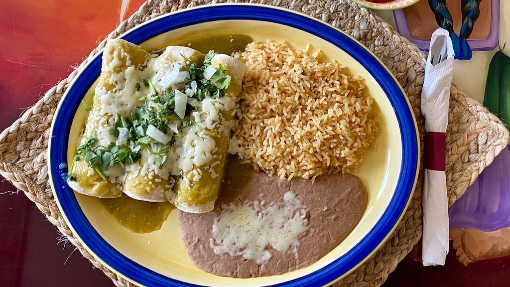 Enchiladas De Carnitas · Three delicious pork carnitas enchiladas with green tomatillo sauce and melted cheese topped with onion and cilantro. Served with Spanish rice and refried beans.