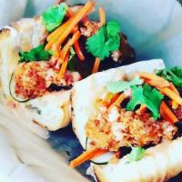 Banh Mi · Fried chicken, pickled vegetables, honey chili mayo, cilantro served on French baguette.