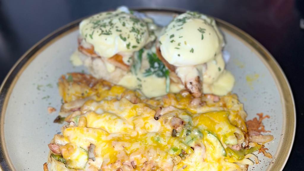 Smoked Salmon Benedict · Smoked salmon, creamed spinach, grilled tomato, capers, hollandaise, loaded hash browns.