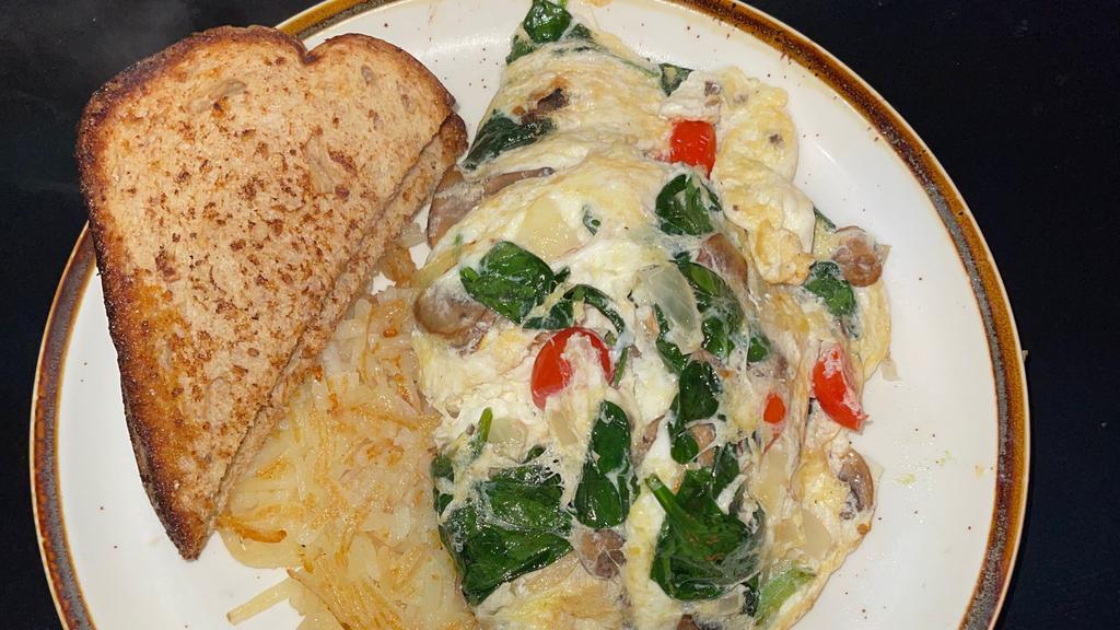 Vegetable Omelet · Egg whites with mushrooms, onions, green bell peppers, tomatoes, and a blend of Monterey Jack and cheddar. Served with a side of fruit and wheat toast.
