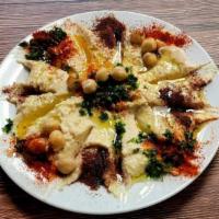 Hummus · Vegetarian. Ground chickpeas blended with tahini, lemon juice, garlic, and house spices. Ser...
