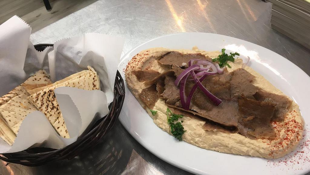 Lulu Hummus · Homemade hummus topped off with your choice of chicken shawarma, lamb, or gyro meat. Served with warm pita bread.
