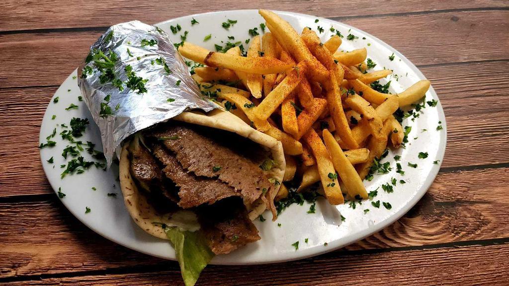 Gyro Pita · Sliced beef and lamb gyro over lettuce, tomato, red onion and grecian sauce. Served with your choice of (1) side.