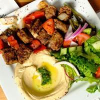 Lula Kabob Dinner · Fresh ground lamb and beef seasoned with parsley, onions, and Lebanese spices. Mixed with gr...