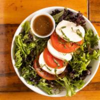Caprese Stack Salad · Mixed greens, fresh mozzarella, sliced tomatoes, basil, with balsamic vinaigrette.