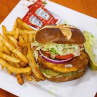 Spicy Chicken Sandwich · Buttermilk fried chicken breast, tossed in Mauricio's hot sauce, topped with lettuce, tomato...