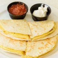 Breakfast Quesadilla · Two scrambled eggs, chopped bacon, monterey jack cheese & cheddar cheese grilled between flo...