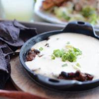 Chili Queso · Served with gluten free blue corn tortilla chips.