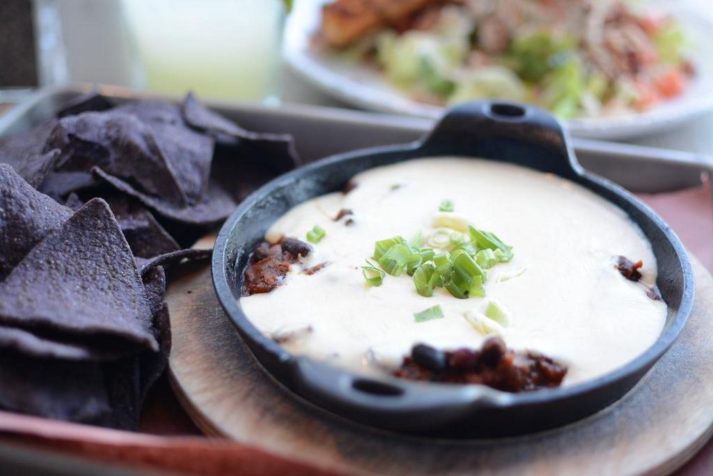 Chili Queso · Served with gluten free blue corn tortilla chips.