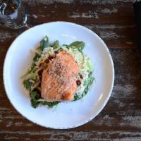 Salmon & Brussels Salad · Smoked salmon filet served over a bed of kale and brussels sprouts with dried cranberries, b...