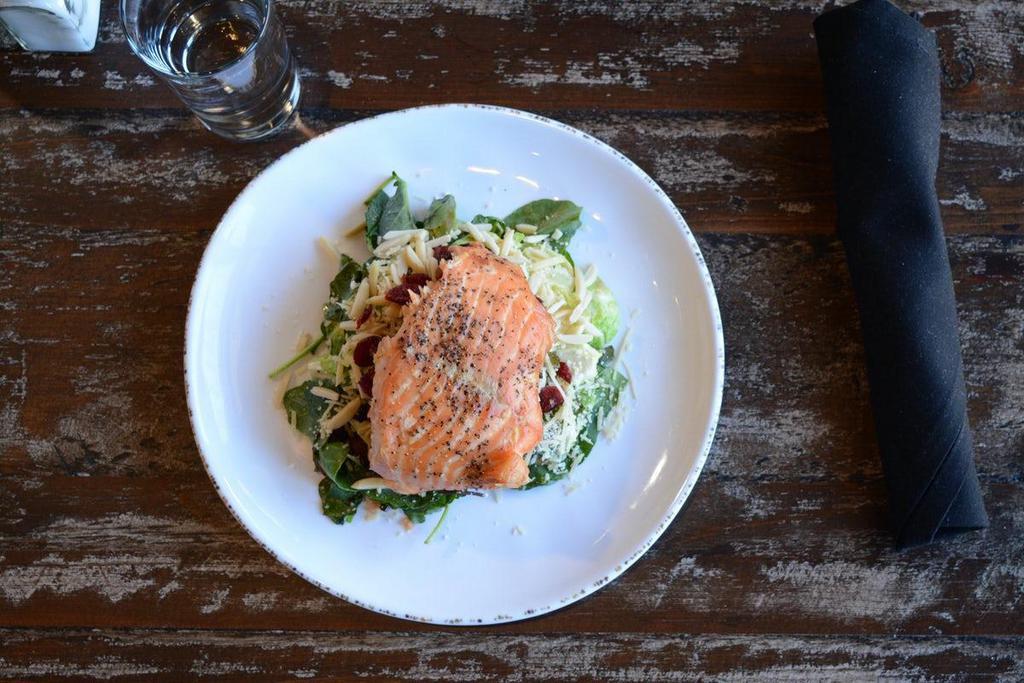 Salmon & Brussels Salad · Smoked salmon filet served over a bed of kale and brussels sprouts with dried cranberries, bacon, fresh grated Parmesan, and toasted almonds served with Maple Tahini dressing.