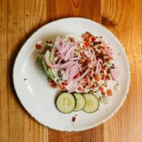 Wedge Salad · Iceberg wedge, tomatoes, cucumbers, pickled red onions, bacon, and Bleu cheese crumbles serv...