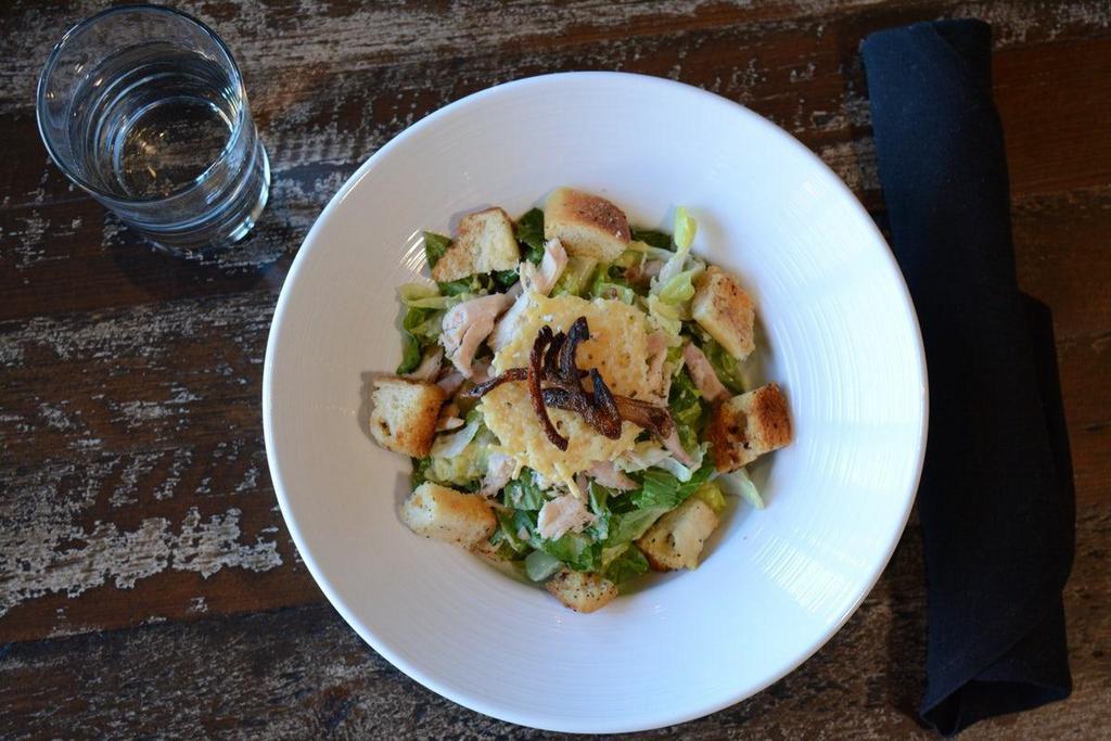 Caesar Salad · Romaine hearts, garlic croutons, parmesan crisps and crispy shallots served with caesar dressing.