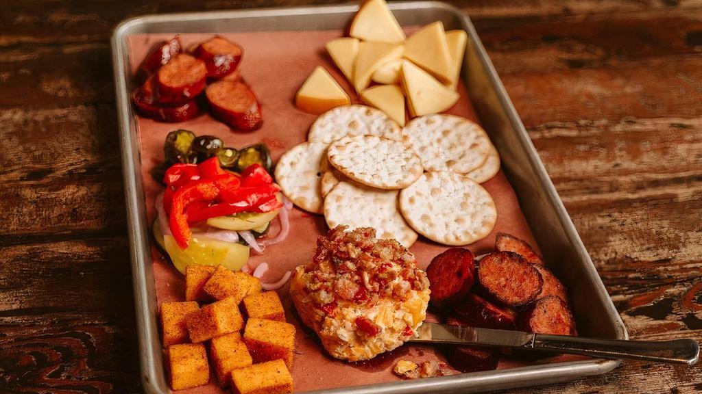 Sausage & Cheese Plate(Half) · Smoked Gouda, rub dusted Cheddar, Pimento cheese and Bacon jam, daily selection and traditional smoked sausage, pickled red onions and House pickles.