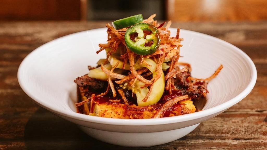 Wrb Grits & Brisket · Baked cheese grits topped with chopped brisket, pickled green tomatoes, jalapeños, crispy onions and Signature sauce.