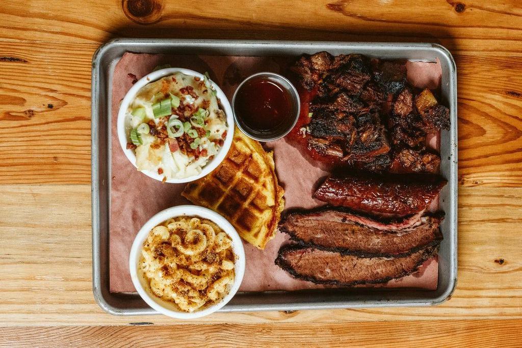 3 Meat Sampler Plate · Try a sample of our Signature smoked meats: sliced brisket (4 oz), burnt ends (6 oz) and smoked sausage. Served with two sides and choice of bread.