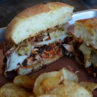 Pulled Chicken Sandwich · Pulled smoked chicken, crispy onions, pickled green tomatoes, bacon, Signature sauce and mel...