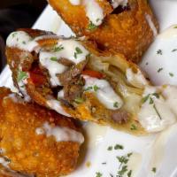 Cheesesteak Egg Rolls · 2 Phillysteak rolls with queso dipping sauce