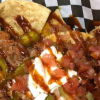 Nashville Nachos · Seasoned tortilla chips, cheddar cheese, bacon, chili, pico de gal with jalapeño and sour cr...
