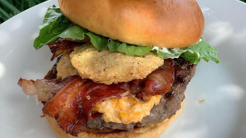 Local Burger · 6 ounces of beef with house-made pimento cheese, honey cured bacon, fried green tomato, lettuce served on a toasted brioche bun