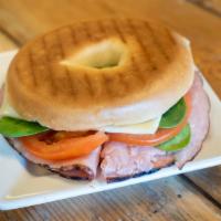 Breakfast Bagel · Ham, spinach, tomato, cheese, and mustard, toasted on a bagel.