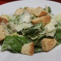 Caesar Salad · Crisp romaine tossed with Caesar dressing & topped with shaved parmesan and house made Asiag...