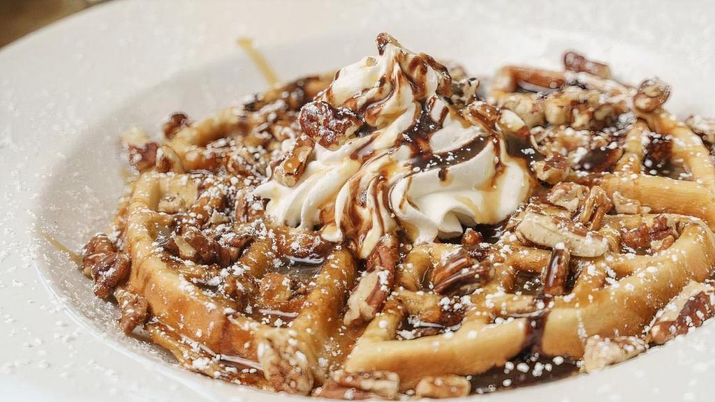 Turtle Waffle · Caramel pecan Belgian waffle drizzled in chocolate and caramel, topped with whipped cream, pecans and confectioners’ sugar.