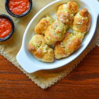 Signature Garlic Knots · Freshly baked with savory blend of fresh garlic, virgin olive oil, oregano and parsley finis...