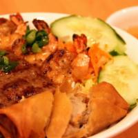 Bun Dac Biet · Grilled pork, shrimp, beef, and crispy roll. Bun. Served cold or warm in a bowl with fresh c...