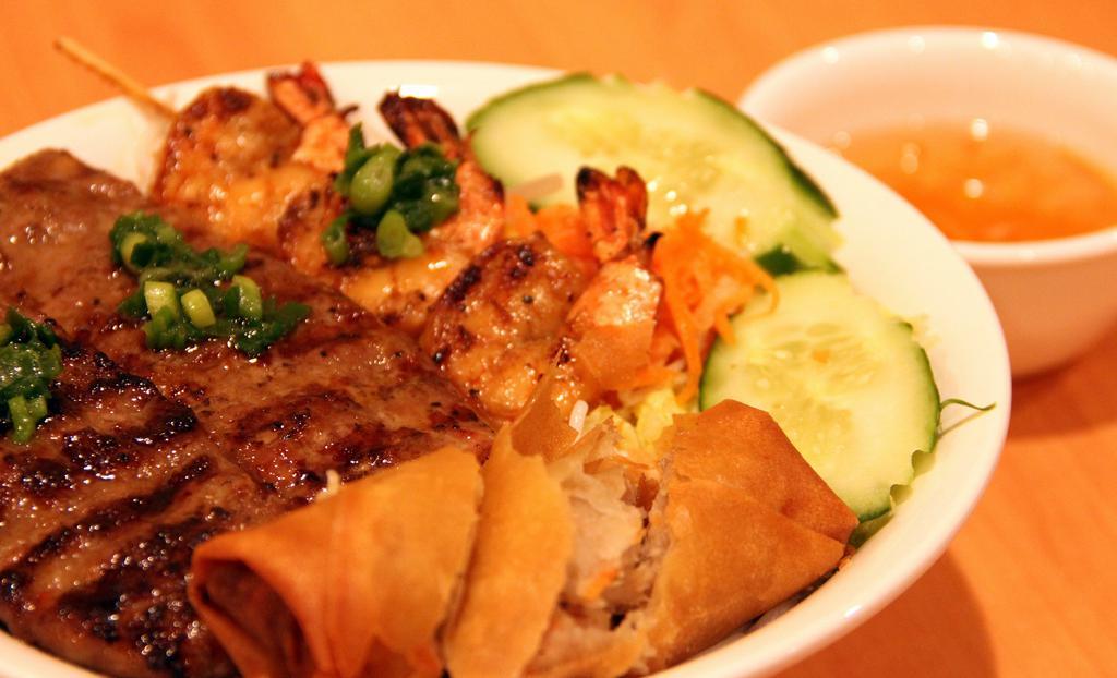 Bun Dac Biet · Grilled pork, shrimp, beef, and crispy roll. Bun. Served cold or warm in a bowl with fresh chopped lettuce, cucumber, bean sprouts, basil, pickled carrots, peanuts, and topped with the meat of your choice.