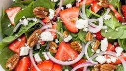 Strawberry Walnut Salad · Spinach, Sliced strawberries, Feta Cheese, Candied Cranberry and Walnuts drizzled with a strawberry vinaigrette dressing