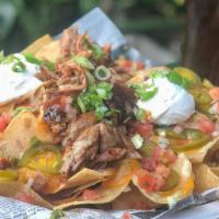 King’S Nachos · Fresh corn tortilla chips covered with mixed cheeses, refried beans, jalapenos, sour cream, ...