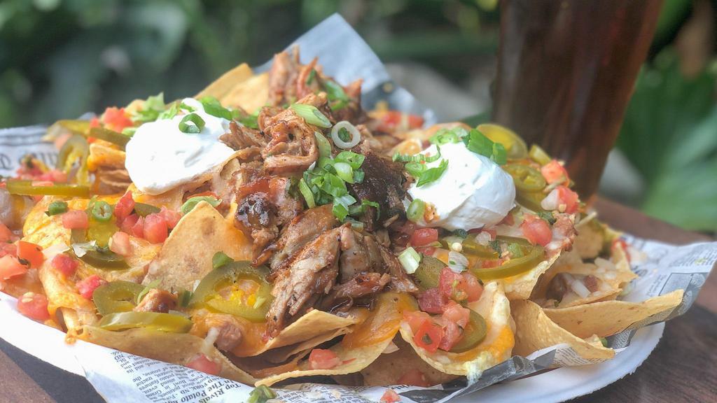 King’S Nachos · Fresh corn tortilla chips covered with a blend of mixed cheeses, refried beans, jalapenos, sour cream, and pico de gallo.