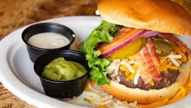 The Works Burger · Topped with applewood smoked bacon, cheddar, and monterey jack cheese, guacamole, jalapenos, and ranch dressing. A half-pound of fresh ground 100% usda choice angus chuck, seasoned, flame-grilled to order with lettuce, tomato, red onions, and pickles. Served on a toasted brioche bun.