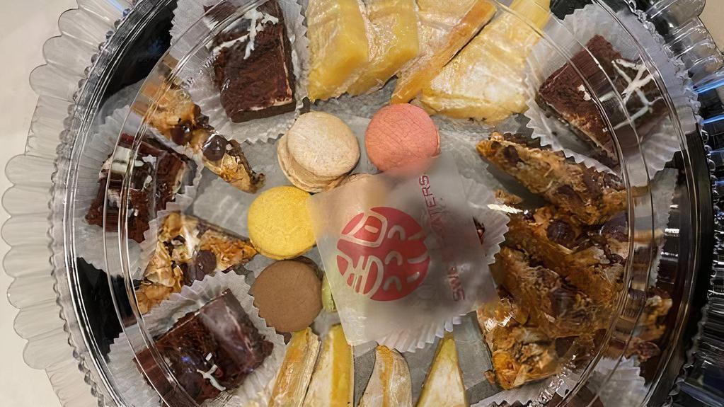 Assorted Sweets Tray · Assortment of brownies, various sweet bars, and macarons.
