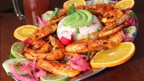 Camarones Don Beto'S · Grilled shrimp, served with bell peppers, onions and tomatoes, rice, orange, cucumber and tostadas.