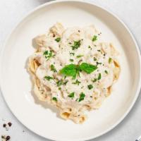 Fettuccine Alfredo · Fettuccine pasta cooked in creamy white sauce and aged parmesan.