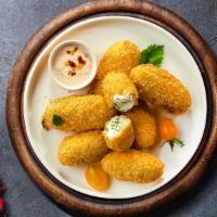 Gooey Jalapeño Poppers  · Fried jalapeños filled with gooey melty cheese, served with ranch.