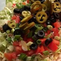 The Ultimate Taco Salad · Spicy beef or chicken, chips, lettuce, tomato, shredded mozzarella, green onions, black oliv...