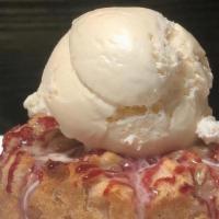 Bread Pudding · Homemade cinnamon sugar bread pudding topped with vanilla ice cream and raspberry drizzle.