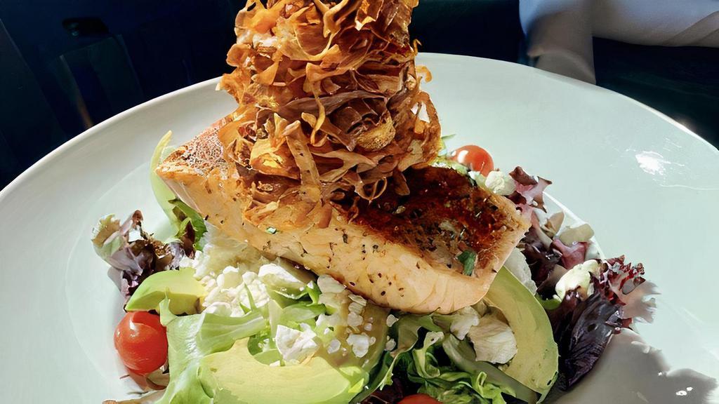 Grilled Salmon Salad · Mixed greens, avocado, tomatoes, feta cheese, crispy parsnip ribbons, grilled salmon.
