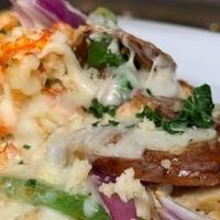 Cajun Crawfish Flatbread · Crawfish tails, blackened chicken, Cajun sausage, peppers, onions, and mozzarella cheese wit...