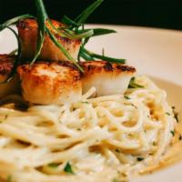 Parmesan Crusted Scallops · Scallops seared with parmesan crust and  crispy capers on angel hair with white wine cream s...