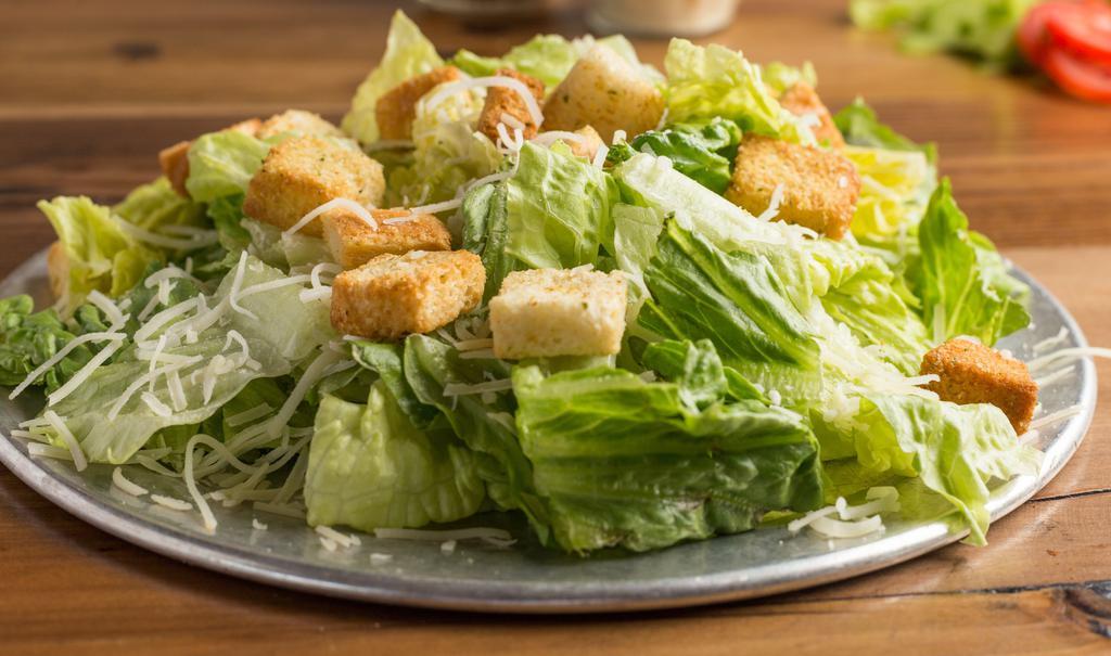 Caesar Salad · Our take on a classic. Romaine lettuce tossed with Parmesan cheese and croûtons in our Caesar dressing. Add chicken for extra flavor. We recommend eating this salad with Caesar dressing.