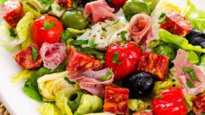 Antipasta Salad · Romaine and iceberg lettuce mixed together then topped with ham, pepperoni, genoa salami, prosciutto, Mozzarella, Provolone, red onion, and Roma tomatoes. Filling and delicious. Served with your choice of dressing.