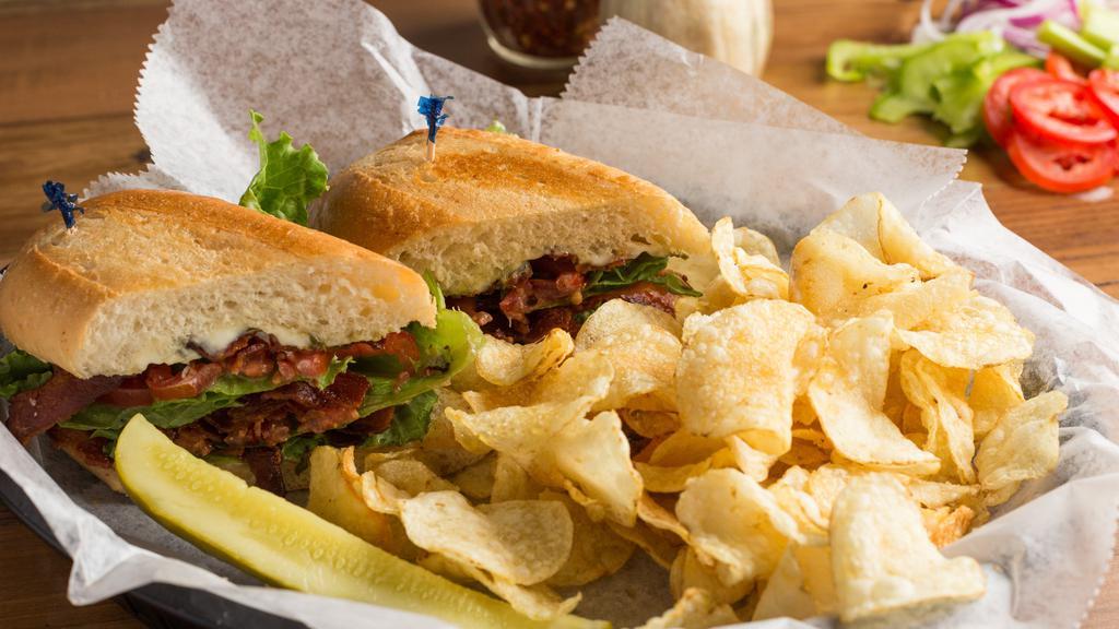 Blt (Bacon, Lettuce, & Tomato) · Served on a hoagie roll (white or wheat), we pile it high with applewood smoked bacon, freshly chopped lettuce, sliced tomatoes, and finish it with a light spread of mayonnaise. Comes with a choice of chips or pasta salad.