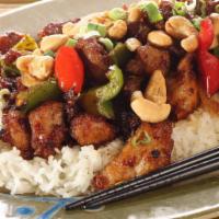 Kung Pao Chicken · Chunks of chicken, peanuts, and vegetables, and chili peppers, served with white rice.