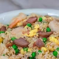 Young Chow Fried Rice · Rice with roast pork, chicken, shrimp, beef, onions, carrots, and peas.