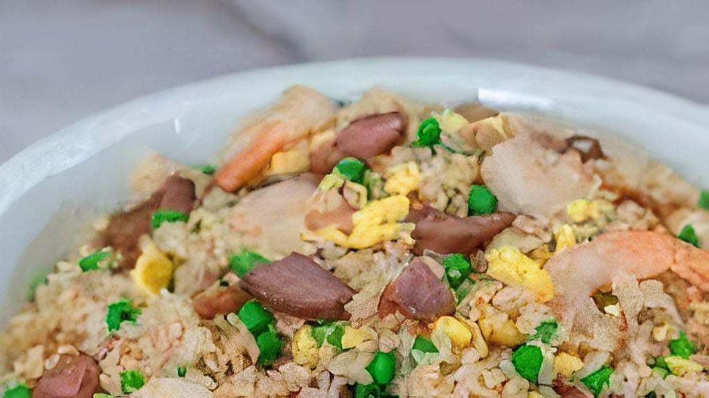 Young Chow Fried Rice · Rice with roast pork, chicken, shrimp, beef, onions, carrots, and peas.